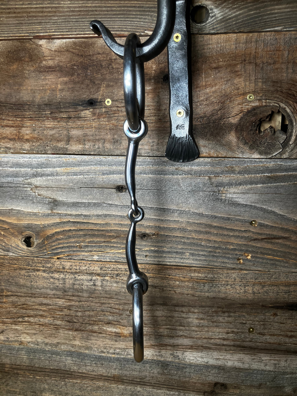 Locked ring curved smooth snaffle