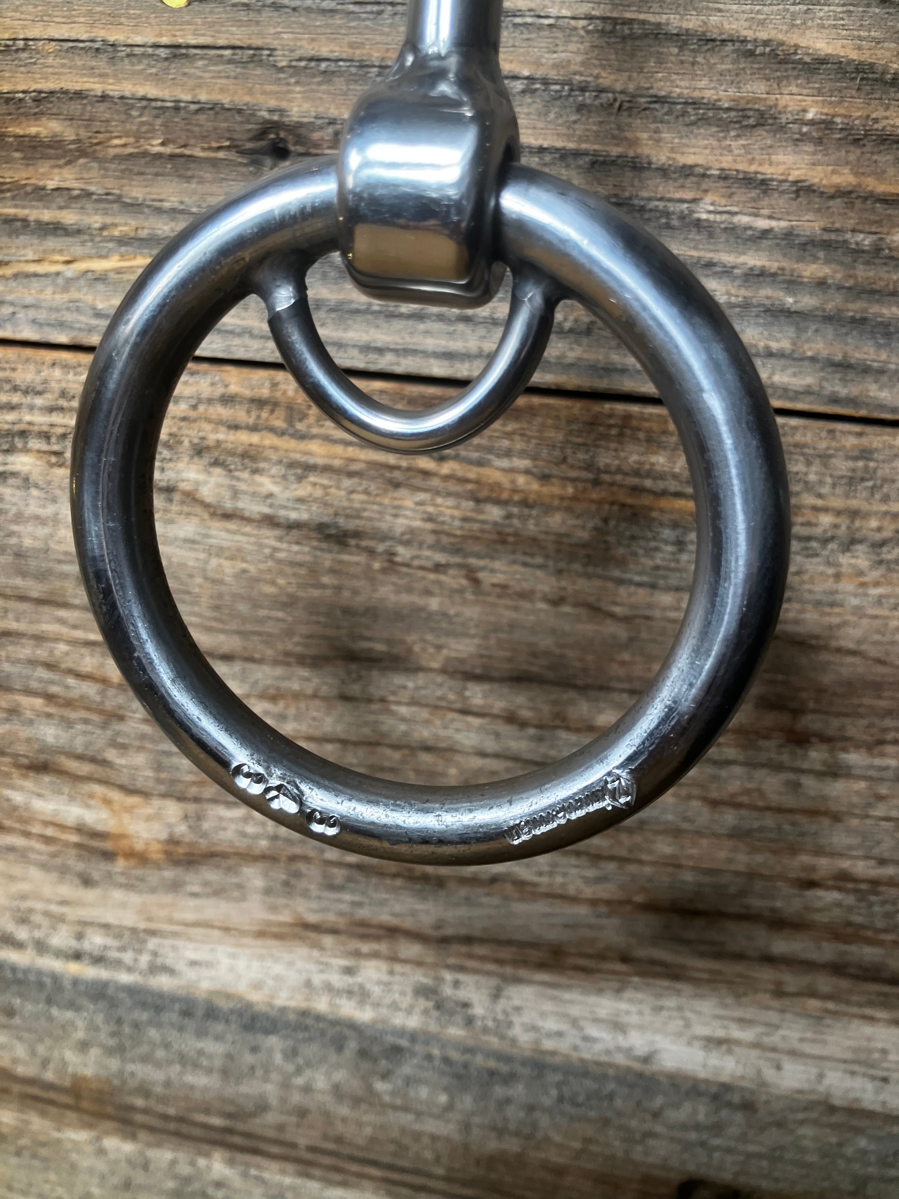 Locked ring curved smooth snaffle