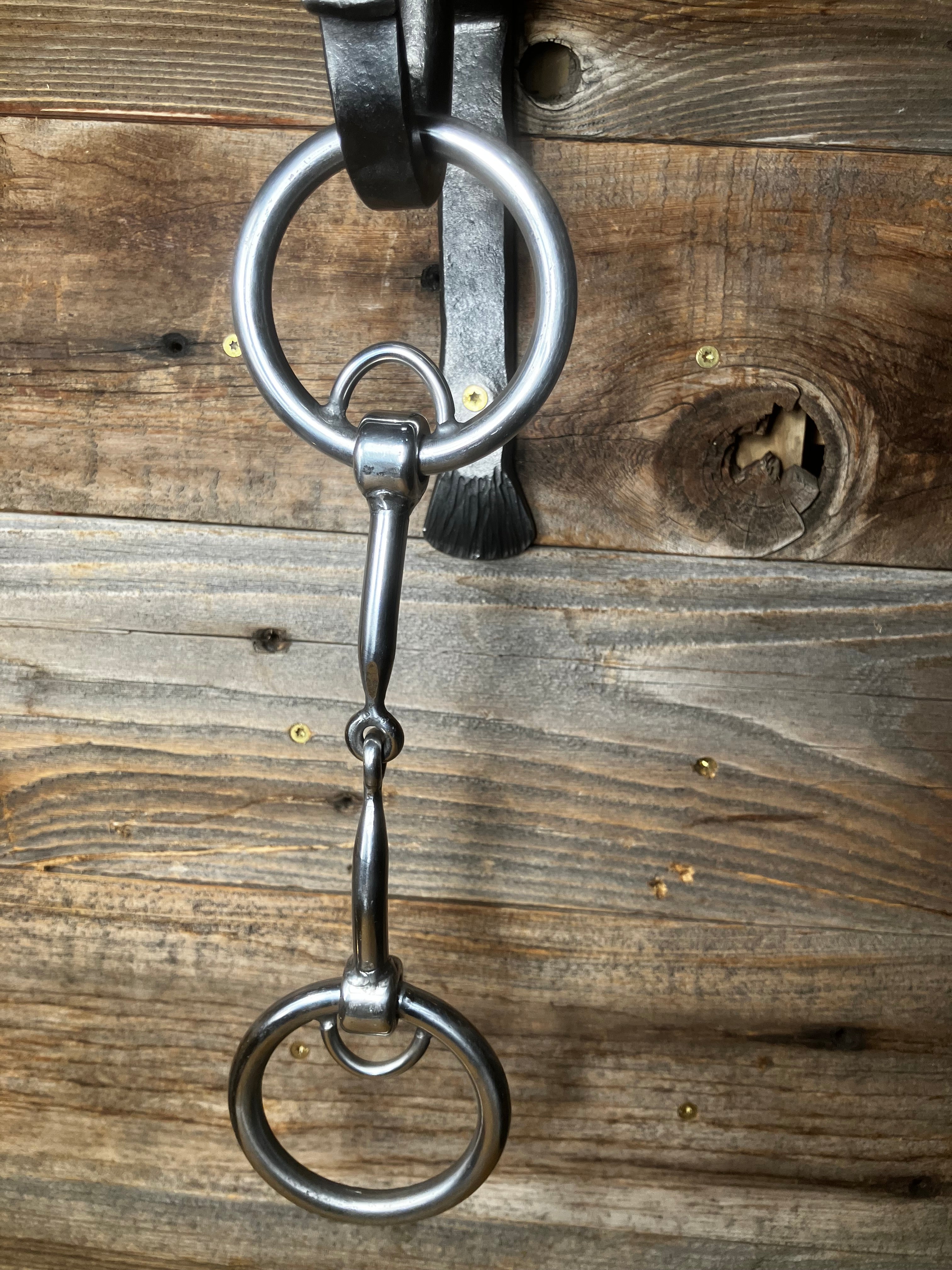 Locked ring curved smooth snaffle